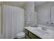 Bathroom features a shower, toilet, sink, and large vanity with dark cabinetry at 9810 Daufuskie Dr, Charlotte, NC 28278