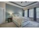 Relax in the main bedroom suite boasting a tray ceiling, neutral decor, and bright windows with shades at 9810 Daufuskie Dr, Charlotte, NC 28278