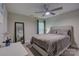 Bedroom boasts a ceiling fan, a mirror, and plush bedding and decor at 9810 Daufuskie Dr, Charlotte, NC 28278