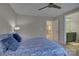 Bedroom featuring a patterned comforter, ceiling fan, and ensuite bathroom at 9810 Daufuskie Dr, Charlotte, NC 28278