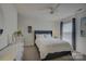 This bedroom boasts neutral decor, an overhead fan, and a bright window with shades at 9810 Daufuskie Dr, Charlotte, NC 28278