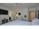 Bright bedroom features a flat screen TV, modern ceiling fan, and ensuite bath at 9810 Daufuskie Dr, Charlotte, NC 28278