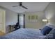 Cozy bedroom features a ceiling fan, a desk, and a bright window at 9810 Daufuskie Dr, Charlotte, NC 28278