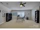 Home office with neutral walls, plush carpet, a large window and multiple shelving units at 9810 Daufuskie Dr, Charlotte, NC 28278
