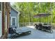 Large outdoor deck with dining area, lounge chair and wooded views at 9810 Daufuskie Dr, Charlotte, NC 28278