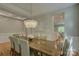 Bright dining room featuring a modern chandelier and open access to the kitchen at 9810 Daufuskie Dr, Charlotte, NC 28278