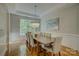 Elegant dining room with hardwood floors, stylish chandelier, and wainscoting detail at 9810 Daufuskie Dr, Charlotte, NC 28278