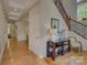 Elegant foyer with hardwood floors, staircase with iron railings, and detailed trim, setting a sophisticated tone at 9810 Daufuskie Dr, Charlotte, NC 28278