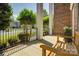 Inviting front porch featuring white pillars and a wooden bench, perfect for enjoying peaceful outdoor moments at 9810 Daufuskie Dr, Charlotte, NC 28278