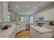 Bright, modern kitchen with white cabinets, stainless appliances, and hardwood floors at 9810 Daufuskie Dr, Charlotte, NC 28278