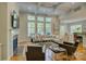 Open-concept living room showcasing hardwood floors, fireplace, and seamless flow to the dining area at 9810 Daufuskie Dr, Charlotte, NC 28278