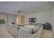 Spacious living room with large sectional, modern fan, and flat screen television at 9810 Daufuskie Dr, Charlotte, NC 28278