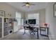 Well-lit home office with ample storage, standup desk, and comfortable workspace at 9810 Daufuskie Dr, Charlotte, NC 28278