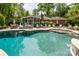 Backyard with large pool, patio space, seating, and lush, mature landscaping at 10316 Whitethorn Dr, Charlotte, NC 28277