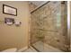 Bathroom featuring a tiled shower with glass door and neutral colored walls at 10316 Whitethorn Dr, Charlotte, NC 28277