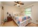 Cozy bedroom with hardwood floors, a ceiling fan, and a bright window at 10316 Whitethorn Dr, Charlotte, NC 28277
