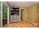 Charming breakfast nook with built-in cabinet, hardwood floors and access to outdoor space at 10316 Whitethorn Dr, Charlotte, NC 28277