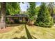 Charming brick home featuring a well-manicured lawn and mature trees at 10316 Whitethorn Dr, Charlotte, NC 28277