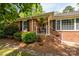 Traditional brick home with a cozy front porch and well-kept landscaping at 10316 Whitethorn Dr, Charlotte, NC 28277