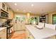 Well-lit kitchen features white countertops, ample cabinetry, and access to outdoor space at 10316 Whitethorn Dr, Charlotte, NC 28277
