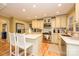 Bright kitchen offers white cabinets, stainless steel appliances, and a functional center island at 10316 Whitethorn Dr, Charlotte, NC 28277