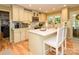 Charming kitchen with white cabinets, island with seating, and stainless steel appliances at 10316 Whitethorn Dr, Charlotte, NC 28277