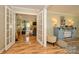 Bright living room with French doors, neutral paint, and wood floors at 10316 Whitethorn Dr, Charlotte, NC 28277