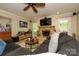 Inviting living room features a fireplace, large TV, and comfortable seating area at 10316 Whitethorn Dr, Charlotte, NC 28277