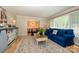 Comfortable living room with blue sofa and a view of the dining area at 10316 Whitethorn Dr, Charlotte, NC 28277
