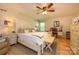 Spacious primary bedroom suite features hardwood floors, a large bed, and natural light at 10316 Whitethorn Dr, Charlotte, NC 28277