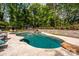 In-ground pool with a stone patio, swing set, and meticulously landscaped backyard at 10316 Whitethorn Dr, Charlotte, NC 28277