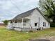 Traditional home featuring a cozy porch and classic architecture, ideal for renovation at 104 E Church St, Dallas, NC 28034