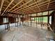 Open layout with exposed beams offers renovation opportunities in this home's interior at 104 E Church St, Dallas, NC 28034