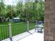New deck overlooking a private backyard featuring mature trees and a storage shed at 107 Garden Ter, Dallas, NC 28034
