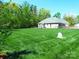 Sprawling backyard featuring mature trees, lawn and the house at 107 Garden Ter, Dallas, NC 28034