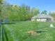 Brick home with a sprawling backyard, storage shed and mature trees at 107 Garden Ter, Dallas, NC 28034