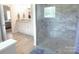 Modern bathroom boasts a glass enclosed shower, stylish tile work, and double vanity at 107 Garden Ter, Dallas, NC 28034
