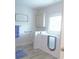 Bright bathroom featuring walk-in tub, linen cabinet, and coordinated fixtures at 107 Garden Ter, Dallas, NC 28034
