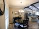 Dining area with a dark table set and view of the kitchen with granite countertops and stainless appliances at 107 Garden Ter, Dallas, NC 28034