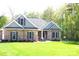 Inviting brick home boasting a well-manicured lawn, landscaped garden beds, and shutters on the windows at 107 Garden Ter, Dallas, NC 28034