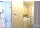 Convenient laundry room with washer, dryer and upper storage cabinets at 107 Garden Ter, Dallas, NC 28034
