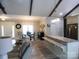 Open-concept living area with wood-look flooring, granite countertops, and exposed beams at 107 Garden Ter, Dallas, NC 28034