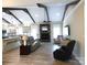 Cozy living space featuring exposed beams, modern furnishings, and a stone fireplace at 107 Garden Ter, Dallas, NC 28034