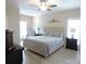 Spacious main bedroom featuring neutral tones, light wood flooring, and a ceiling fan with a light at 107 Garden Ter, Dallas, NC 28034