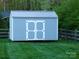 Storage shed with a metal roof in the backyard with split rail fence at 107 Garden Ter, Dallas, NC 28034