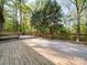 Large wooden deck surrounded by trees and wooden railing offers space for outdoor enjoyment at 110 Dutch Creek Rd, Rockwell, NC 28138