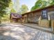 Exterior back of the house shows a wooden deck, siding, and steps leading down to the yard at 110 Dutch Creek Rd, Rockwell, NC 28138