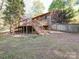 Backyard of the house features a wooden deck, siding, steps, and green yard at 110 Dutch Creek Rd, Rockwell, NC 28138