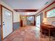 Spacious basement featuring tile flooring, a desk, and a walkout to the exterior at 110 Dutch Creek Rd, Rockwell, NC 28138