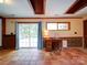 Bright basement with tile flooring, a desk, and sliding glass doors leading to an outdoor deck at 110 Dutch Creek Rd, Rockwell, NC 28138